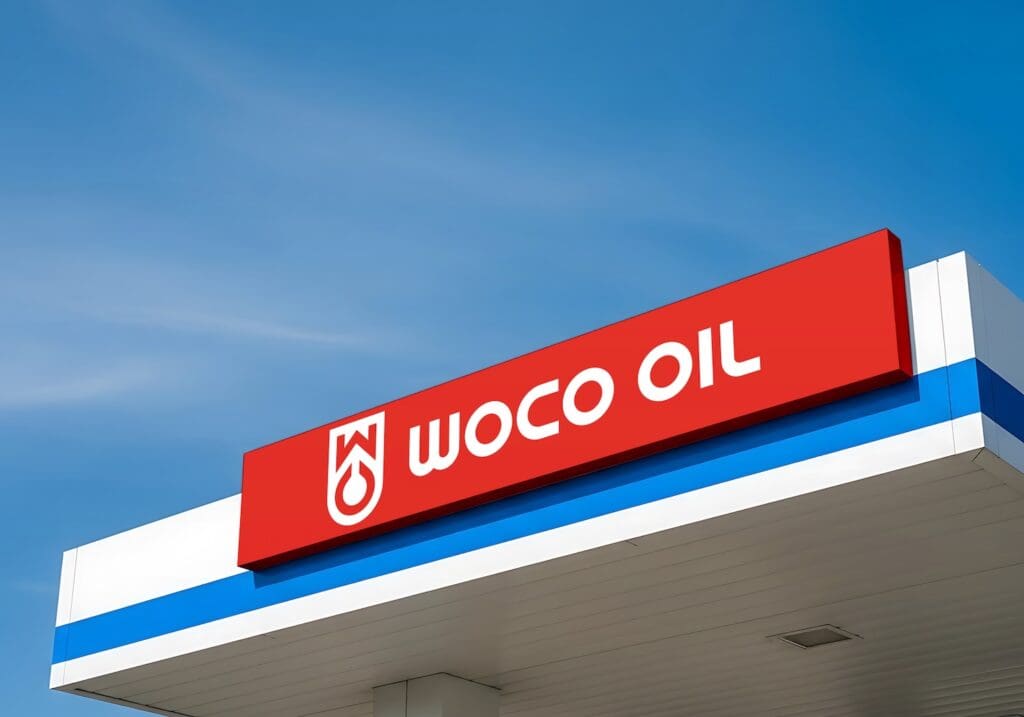 A mockup of the WOCO Oil logo on a gas station